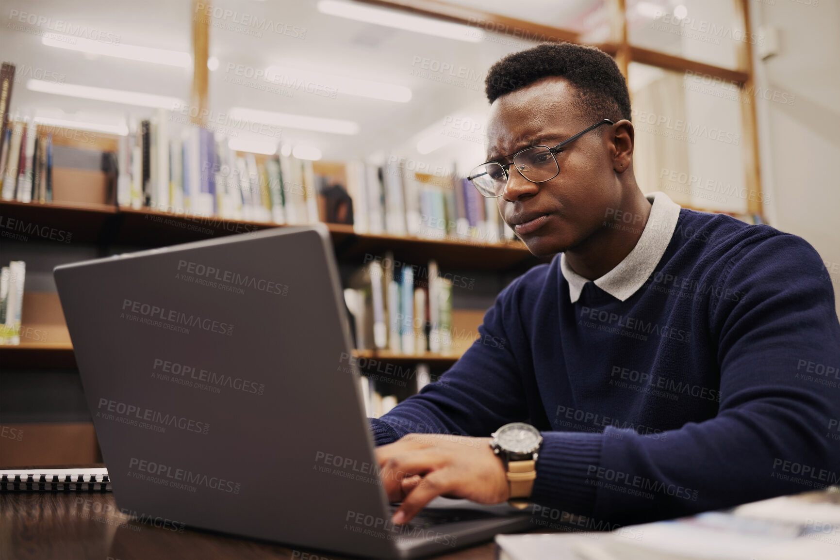 Buy stock photo Student, frustrated and black man typing on a laptop in university or college campus angry due to assignment project. Online, studying and young person prepare for internet exam or doing research 