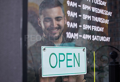 Buy stock photo Shop, window and happy businessman open with sign for working time in retail, store or service in small business. Opening, restaurant or startup owner in Portugal with a welcome, poster and smile 