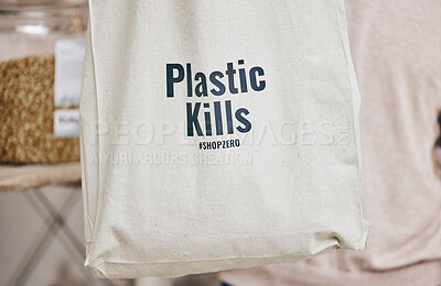 Buy stock photo Eco friendly grocery store, recycling fabric shopping bag and commitment to climate change at sustainable small business. Zero waste, plastic kills logo and supermarket with carbon footprint choice.