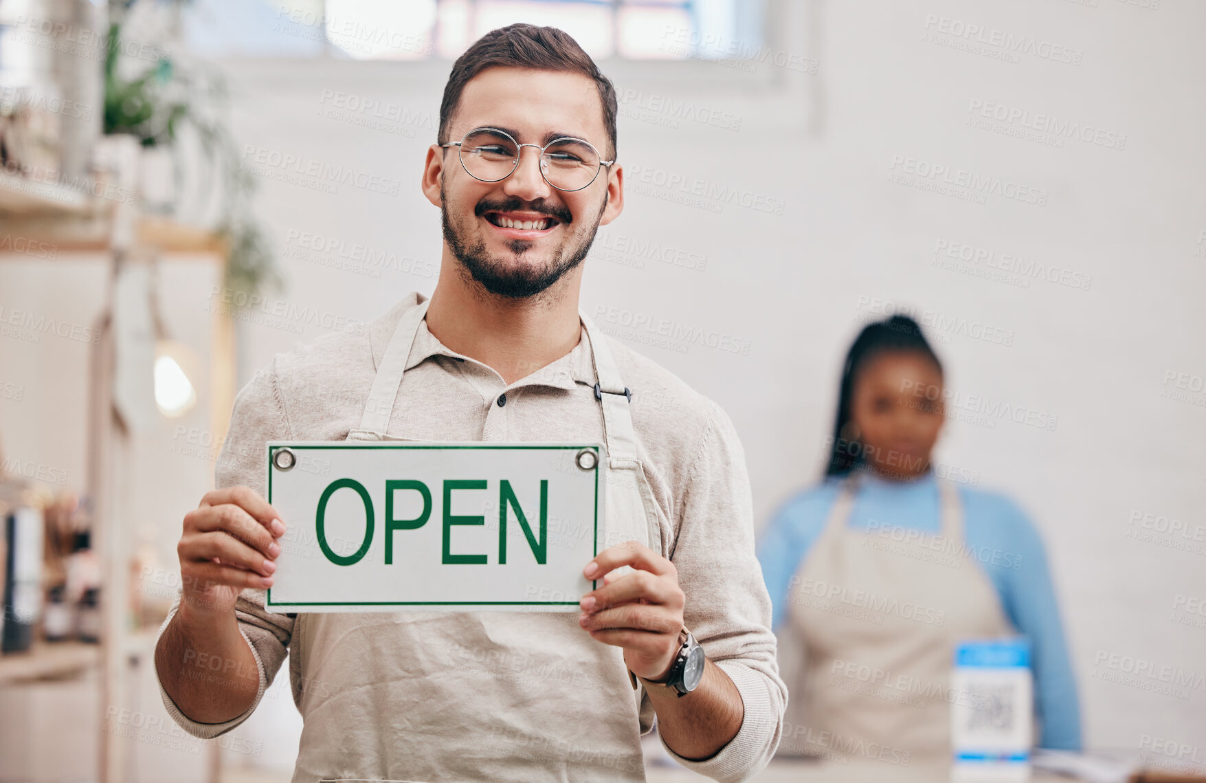 Buy stock photo Open, sign and man with small business or restaurant happy for service in a coffee shop, cafe or store with a board. Smile, manager and portrait of an entrepreneur ready for operations with billboard