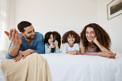 Buy stock photo Bed, happy family children and parents watching tv series, movies or online streaming service, entertainment or video. Bedroom, home and relax mother, father and kids watch show, television or film