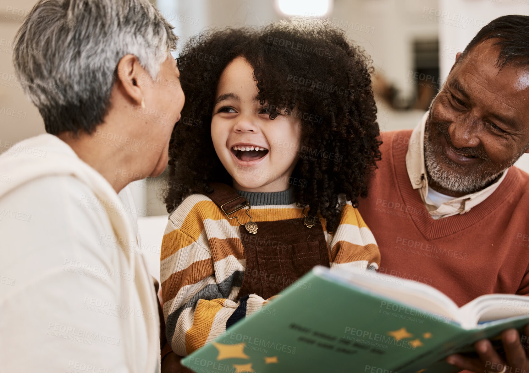 Buy stock photo Grandparents, kid and happy for reading, book or home for support, learning or education with laugh. Senior man, woman and young child for funny story, teaching or help for development in family home