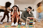 Parents, floor and stress with children running, toys or motion blur for speed, game or overwhelmed in home. Mother, dad and kids on carpet, living room and family house in chaos, anxiety or burnout