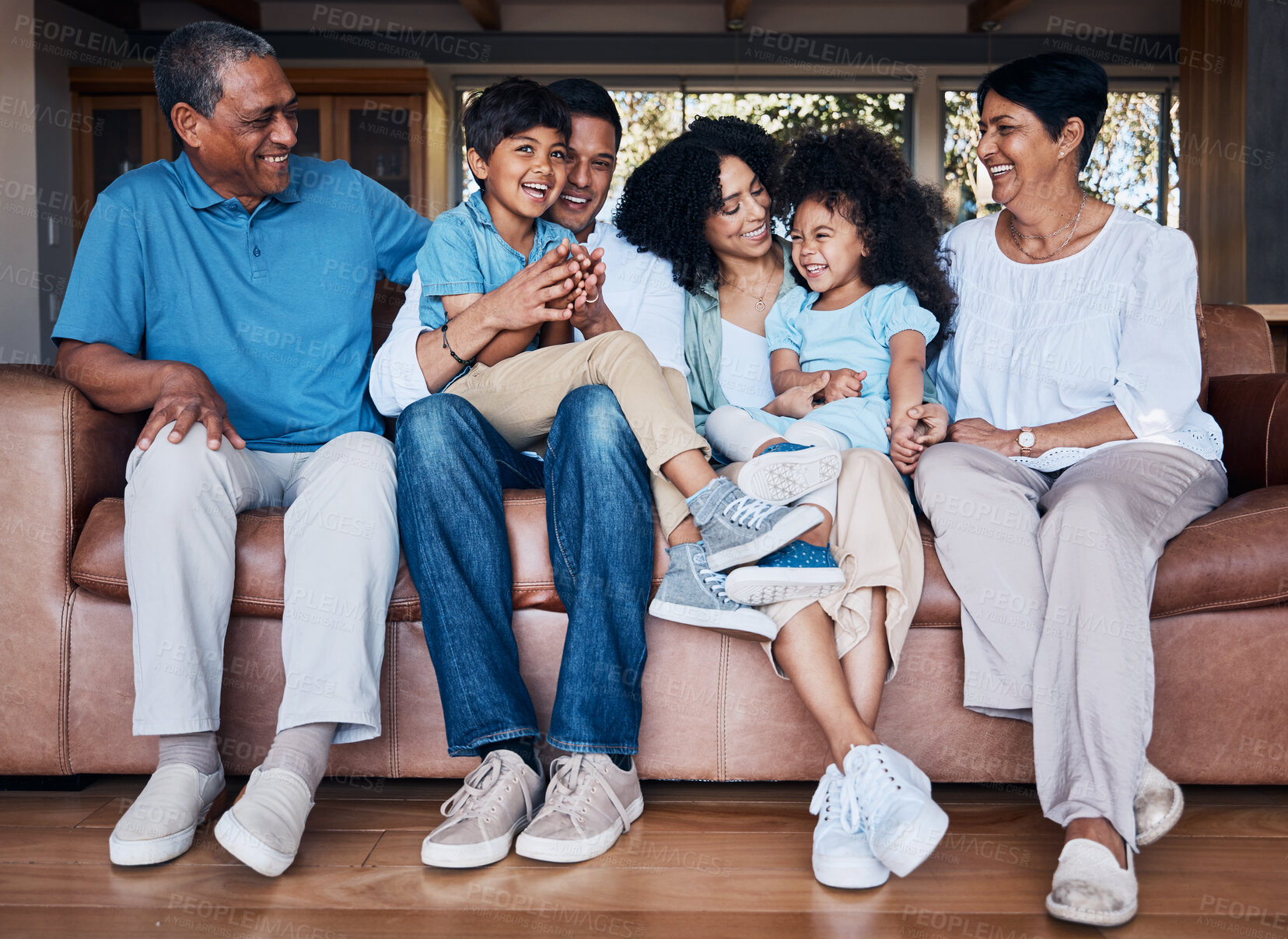 Buy stock photo Happy, funny and relax with big family on sofa for smile, bonding and peace. Love, generations and grandparents with parents and children in living room at home for vacation, cuddle and embrace