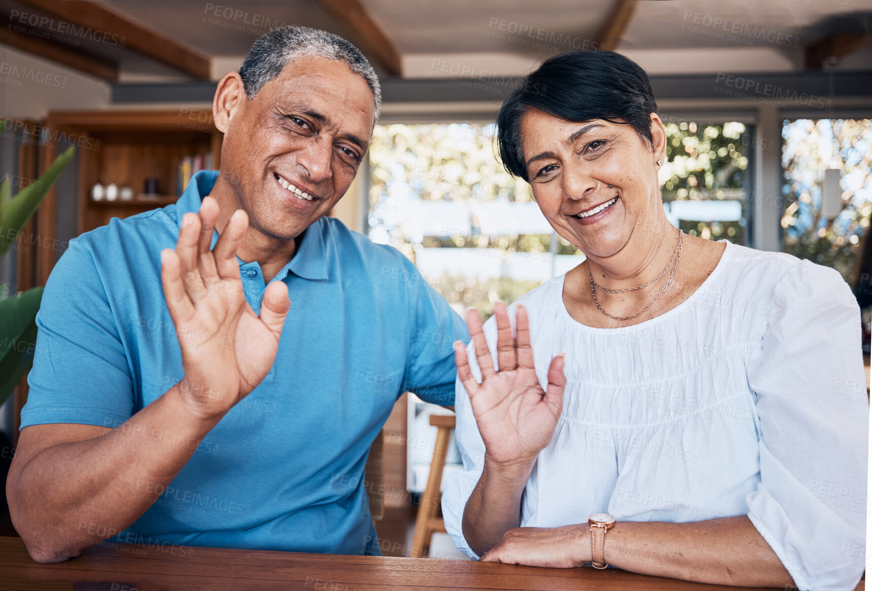 Buy stock photo Video call, wave and portrait of senior couple with communication in the dining room at home. Happy, smile and elderly man and woman in retirement greeting for an online virtual conversation together