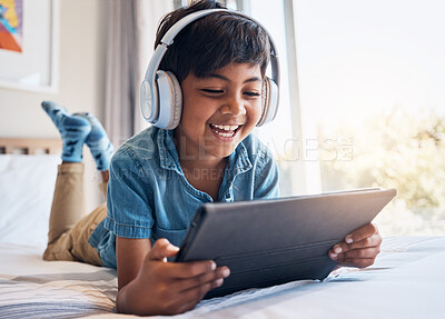 Buy stock photo Happy boy, tablet and headphones on bed, smile or relax for streaming subscription, movie or funny video. Male child, digital touchscreen and happy in bedroom with audio tech, show or cartoon in home