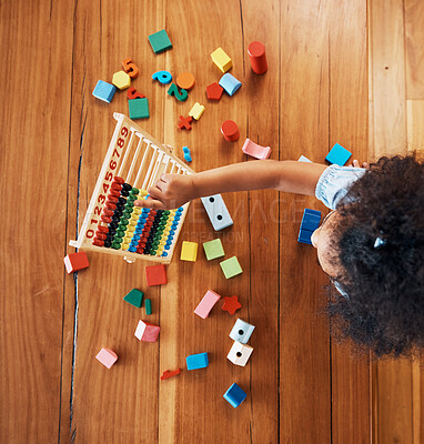 Above, child and toys for math on the floor, home education and fun activity. House, young and a girl kid with blocks and abacus for recreation, counting or perspective on the ground in childhood