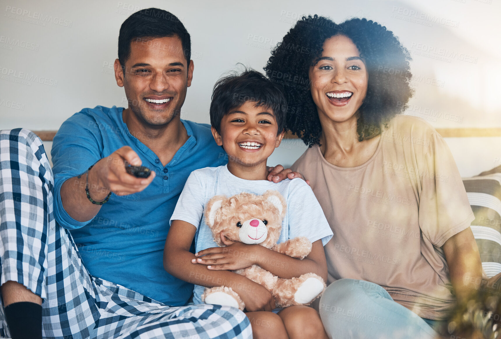 Buy stock photo Happy, morning and a family watching tv on bed in their home together for streaming or entertainment. Parents, children or funny boy in the bedroom with his mom and dad to enjoy a television movie