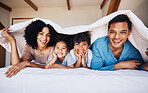 Happy, smile and portrait of a family with a blanket for relaxing, bonding or resting together. Happiness, love and young children with their parents from Colombia on the bed in room of their house.