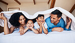 Smile, talking and family on a bed with a blanket for relaxing, bonding or resting together at home. Happiness, excited and young children with their parents from Colombia in the room of modern house