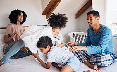 Buy stock photo Happy family, parents and children on bed, pillow fight and relax together on weekend morning with fun. Mom, dad and kids in bedroom, playing and bonding in home with love, care and playful games.