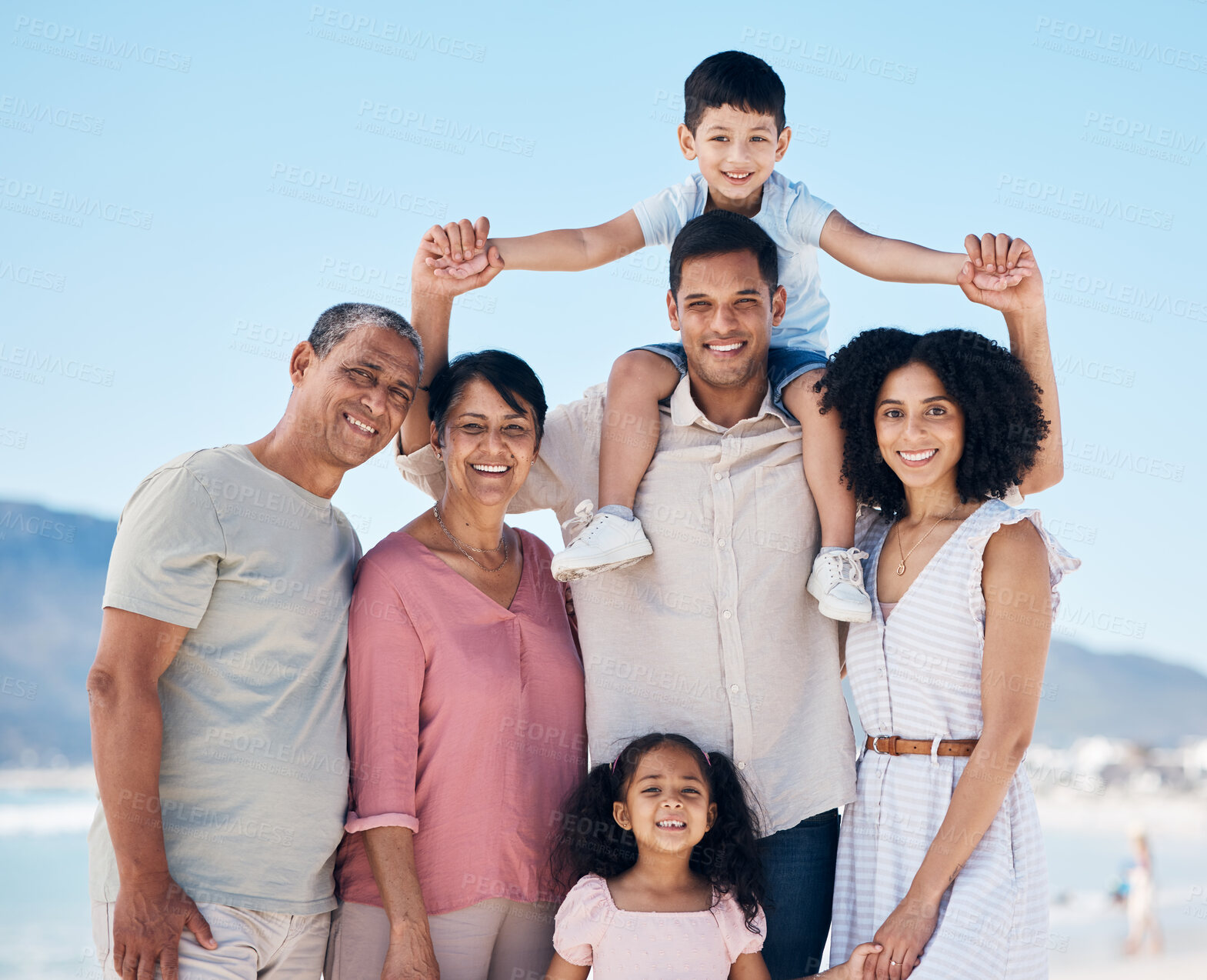 Buy stock photo Beach, big family and portrait together with smile, love and generations embrace on summer holiday in Mexico. Happy parents, grandparents and children on ocean holiday travel in nature with blue sky.