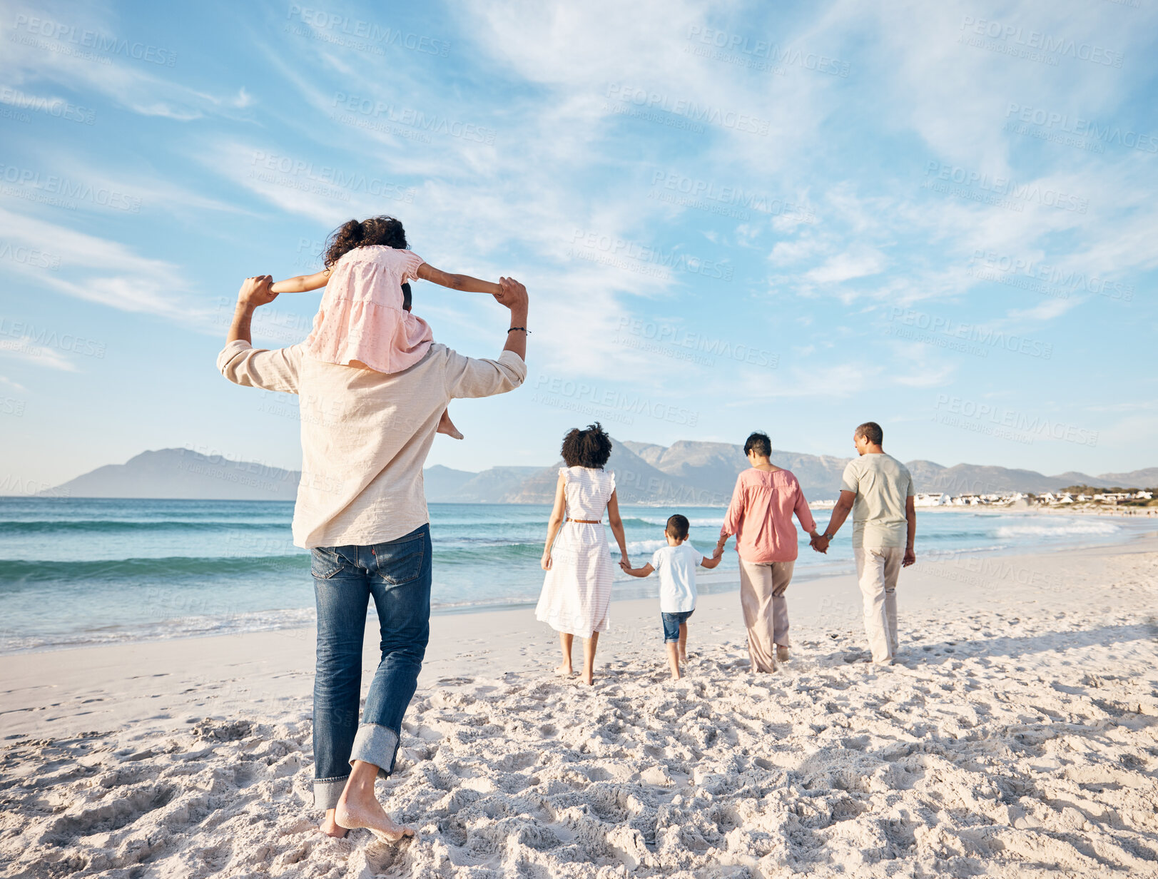 Buy stock photo Big family, holiday and walking on beach, holding hands and piggy back on summer island sand from behind. Parents, grandparents and kids adventure on tropical vacation together at ocean in Hawaii.