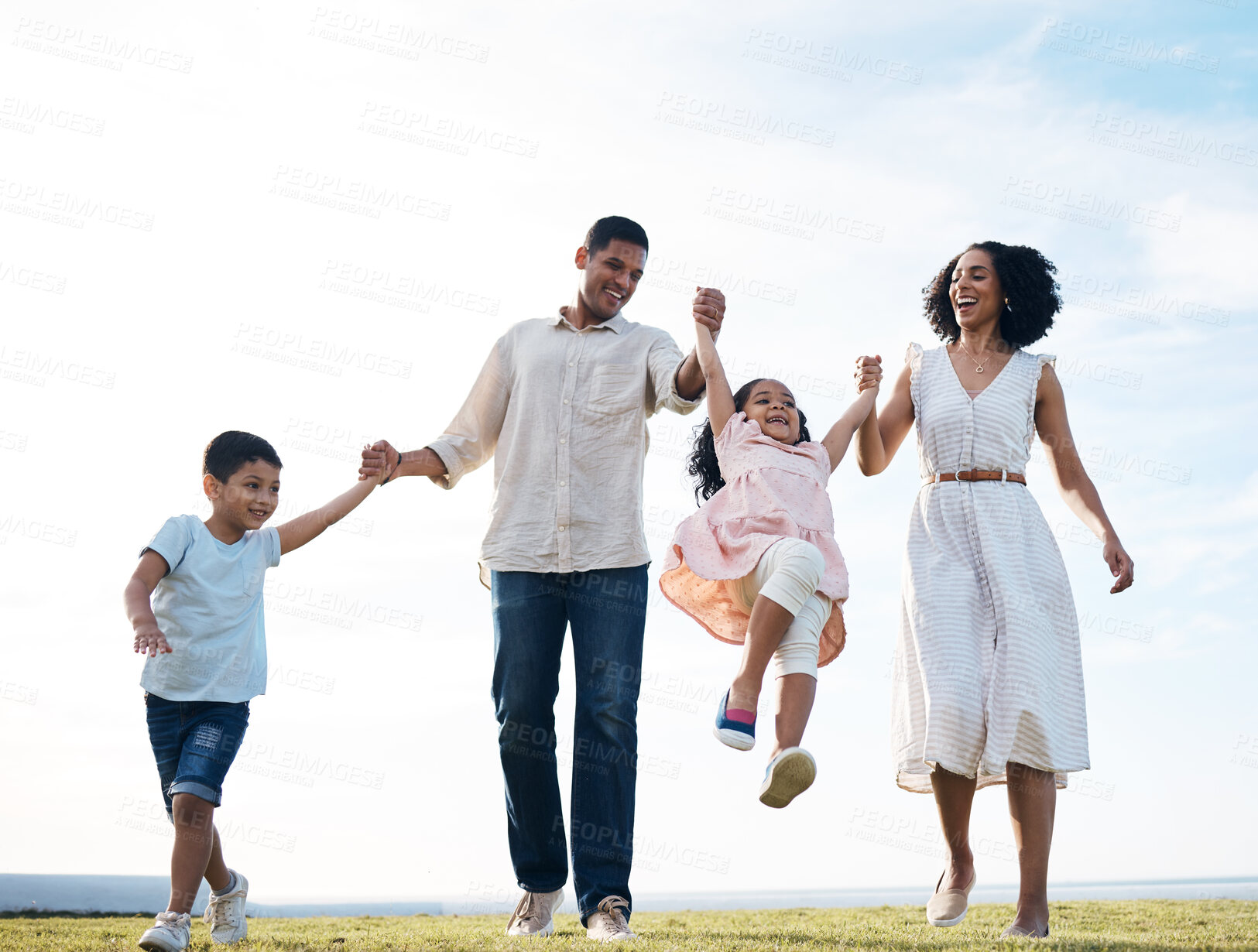 Buy stock photo Family, walking and holding hands outdoor at a park with love, care and happiness together in nature. Young man and woman or parents swing children or playing on fun journey, travel or holiday