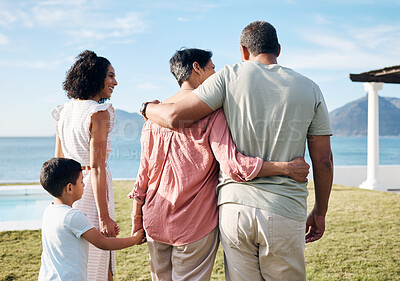 Buy stock photo Back, summer and vacation by the sea with family outdoor together looking at a view of nature. Grandparents, mother and happy son by the ocean for love, holiday freedom or weekend getaway and travel