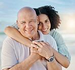 Beach, portrait and woman with her senior dad on family vacation, holiday or adventure. Happy, smile and young female person hugging her elderly father with love and care by the ocean on weekend trip