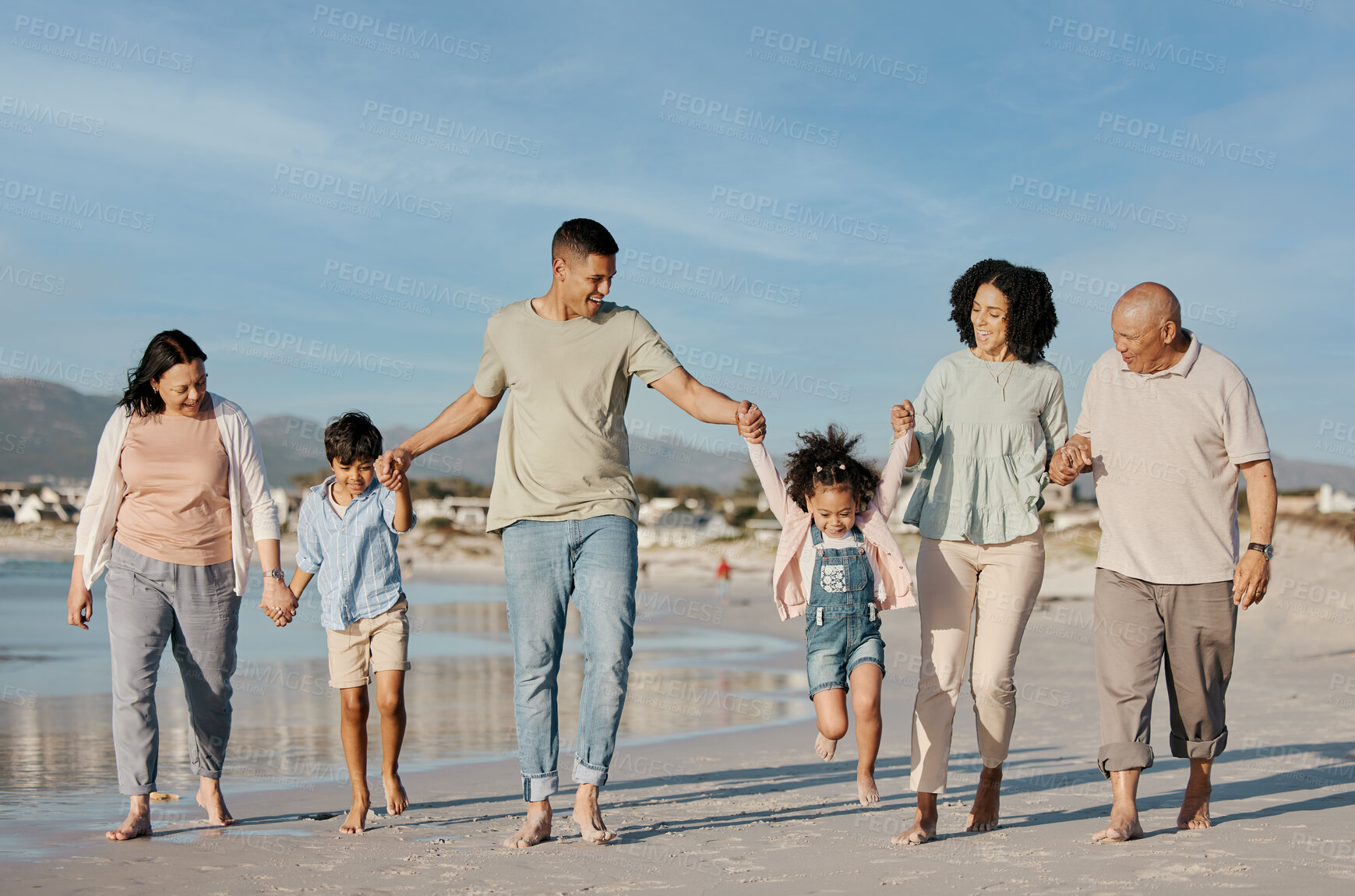 Buy stock photo Walking, happy and family outdoor on a beach with love, care and happiness on travel vacation. Parents, grandparents or men and women holding hands of children for holiday, journey or fun adventure