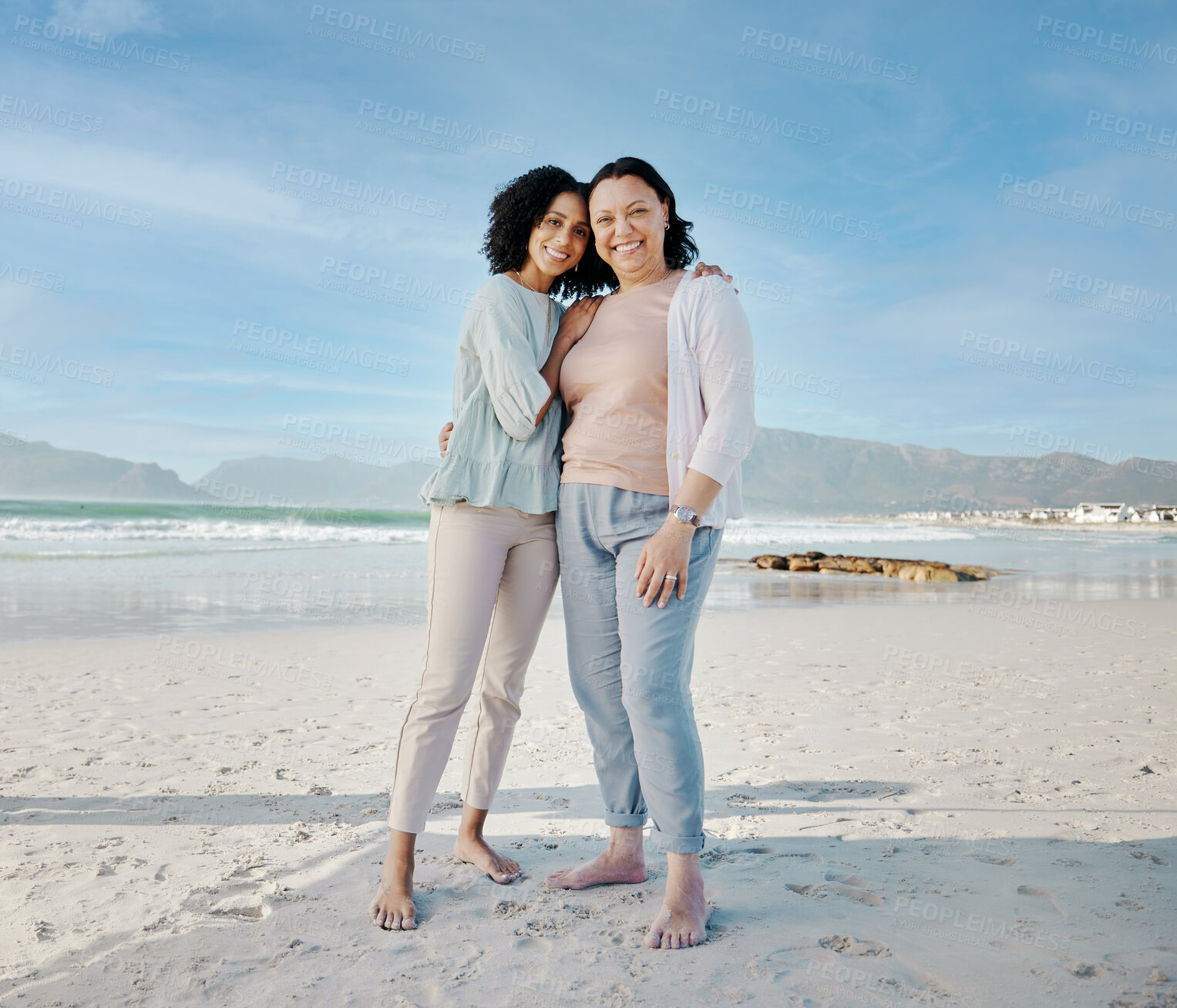 Buy stock photo Hug, portrait and woman with mother at a beach happy, bond and relax in nature together. Love, smile and lady face with mom the ocean for freedom, travel and adventure trip at the sea in South Africa