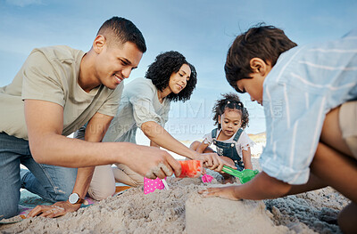 Buy stock photo Parents, children and sandcastle at beach, bucket and digging for bonding, outdoor and vacation in summer. Mother, father and kids with plastic toys, sand and games on holiday, teamwork and ocean