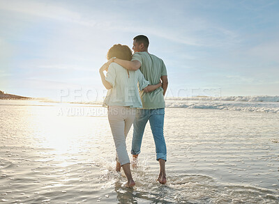 Buy stock photo Love, hug and back of couple at the beach walking, bond and relax in nature on blue sky background. Ocean, love and rear view of man embrace woman at sea for travel, freedom and romantic walk in Bali