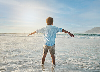 Buy stock photo Freedom, fun and child in waves at beach, playful on tropical summer holiday in Australia with blue sky. Ocean, adventure and sun, back of boy in water and playing with energy on island vacation