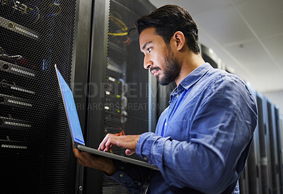 Buy stock photo Connectivity, data center and a man with a laptop for maintenance, cyber security and internet check. Coding, email and an Asian programmer typing on a computer for network or server analytics