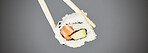 Seafood, sushi and chopsticks in studio, salmon roll isolated for healthy Asian dining promo. Japanese food culture with rice, raw fish and avocado, restaurant menu offer or deal on grey background.