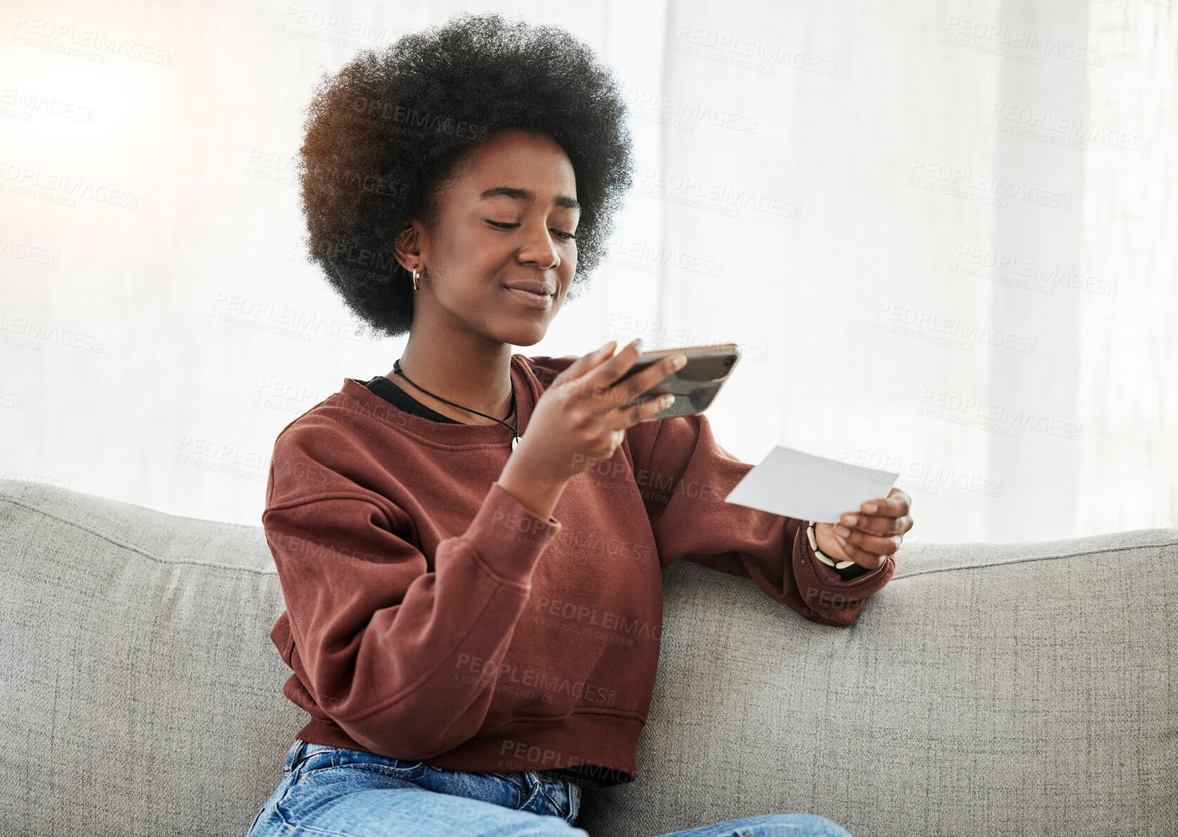 Buy stock photo Paper, phone and black woman taking a picture on a sofa in the living room of her apartment. Technology. slip and young African female person with a cellphone for a photo in the lounge of her home.