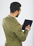 Back, business and man with a tablet, career and professional on a white studio background. Japanese person, employee and accountant with tech, connection and data analysis with investment or trade