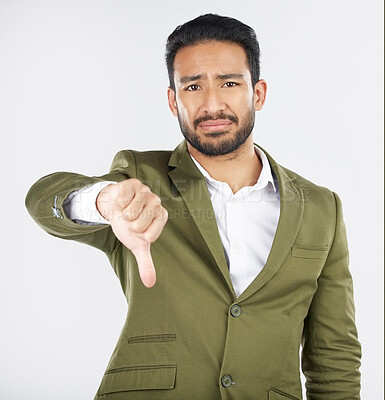 Buy stock photo Sad, portrait and man with thumbs down in studio for rejection, no or bad review on grey background. Face, frown and Japanese model with emoji finger for negative, vote or feedback fail or opinion