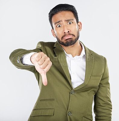 Buy stock photo Portrait, frown and man with thumbs down in studio for rejection, no or bad review on white background. Face, sad and Japanese model with emoji hand for negative, vote or feedback fail and opinion