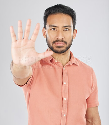Buy stock photo Stop, hand and portrait of asian man in studio with warning, control or protection order on grey background. Protest, palm and face of Japanese male model with no, emoji and limit, ban or threat sign