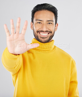 Buy stock photo Man, palm and stop in studio portrait, smile and emoji for opinion, rejection or no by white background. Young Indian guy, student or fashion model with hand, sign language or show gesture for review