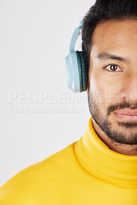 Buy stock photo Half portrait, man and headphones on a white background for a podcast, music or streaming radio. Serious, face and an Asian person listening to sound, audio or a track isolated on a studio backdrop
