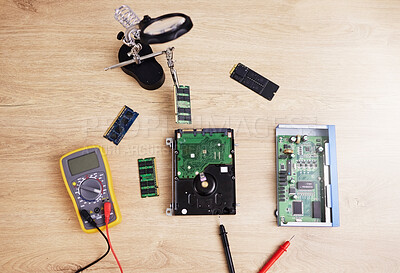 Motherboard, engineering and electrical hardware for maintenance, repair or fixing with equipment. IT, circuit developer and top view of a dashboard microchip with tools for an update on a wood table