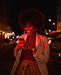 Happy black woman, afro and phone at night in city for communication, social media or outdoor networking. African female person smile in online chatting or late evening on mobile smartphone in town