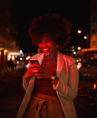 Buy stock photo Happy black woman, afro and phone at night in city for communication, social media or outdoor networking. African female person smile in online chatting or late evening on mobile smartphone in town