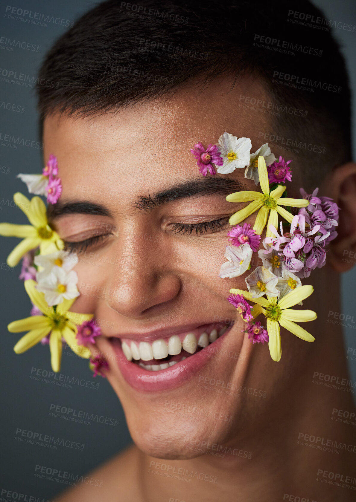 Buy stock photo Face, man and smile, flowers and beauty, natural cosmetics and headshot with art deco isolated on studio background. Nature aesthetic, dermatology with eco friendly skincare and clean with spring