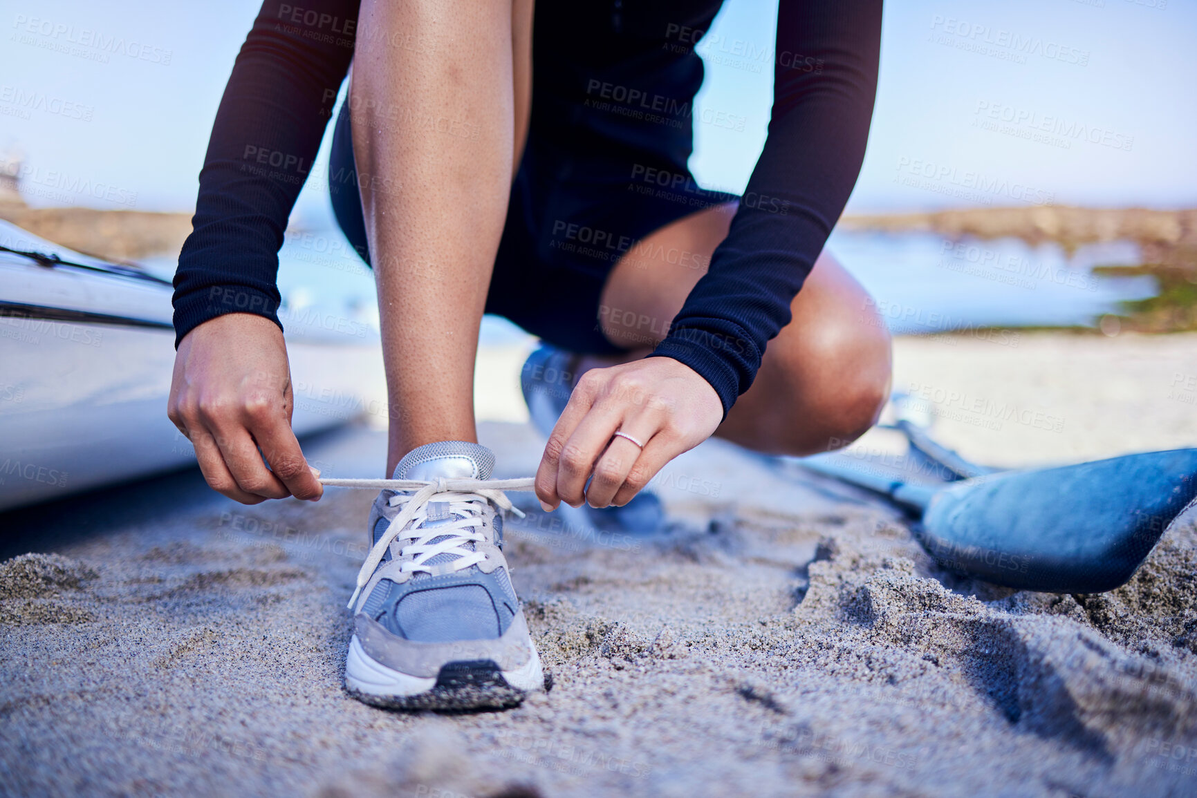 Buy stock photo Hands tie shoes, beach and athlete start workout, training and kayak exercise outdoor. Sand, person and tying sneakers at ocean to prepare in fitness, sports and healthy body for wellness in summer.