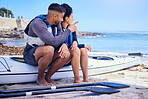 Couple, talking and outdoor for kayak or travel at a beach with a partner for teamwork. A man and woman with a canoe for sports, water adventure and vacation or freedom pointing at space in nature