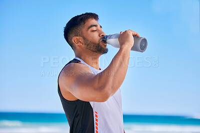 Buy stock photo Man, fitness and drinking water on beach in hydration after workout, training or outdoor exercise. Thirsty or sporty male person in healthy diet, natural nutrition or mineral in sustainability by sea