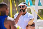Volleyball, coach whistle and man in a match, competition and sport outdoor with clipboard. Workout, game and male person with people, athlete and beach court on sand in summer with notes by ocean