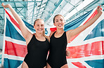 Athlete women, British flag and celebration for win, fitness or excited smile in portrait at sports contest. Girl team, winner and hug by swimming pool for success, exercise and goals at competition