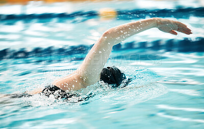 Sports, water or person training in swimming pool for a race competition, exercise or cardio workout. Strong swimmer, wellness or arm of athlete exercising with fitness speed in practice or race