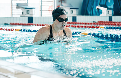 Swimming, athlete and sports woman in water for training, action and performance in competition, race and challenge. Pool, swimmer and underwater goggles for fitness, triathlon contest and exercise