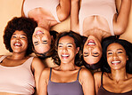Beauty, above and happy diversity of women with smile for skincare isolated in a studio brown background together. Support, portrait and group of friends with care laying on floor for skin or makeup