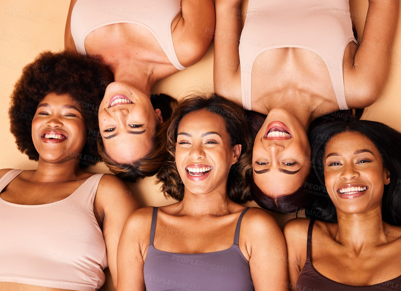 Buy stock photo Beauty, above and happy diversity of women with smile for skincare isolated in a studio brown background together. Support, portrait and group of friends on a floor for skin, care or face makeup