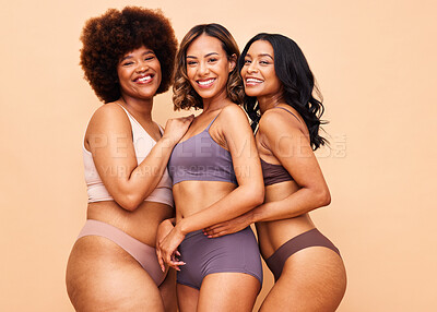 Buy stock photo Diversity, body positivity and portrait of women with smile, self love and solidarity in studio together. Happiness, group of people on beige background with underwear, skincare and cosmetic equality