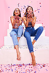 Party, fashion and women in studio with confetti for celebration, clothing sale and discount. Beauty, diversity and female people on pink background for cosmetics, trendy clothes and denim outfit