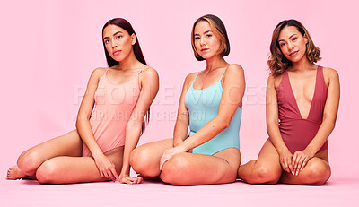 Buy stock photo Swimsuit, studio and portrait of women together with bikini, underwear and body positivity. Diversity, summer fashion and swimwear models sitting with self love, equality and glow on pink background.